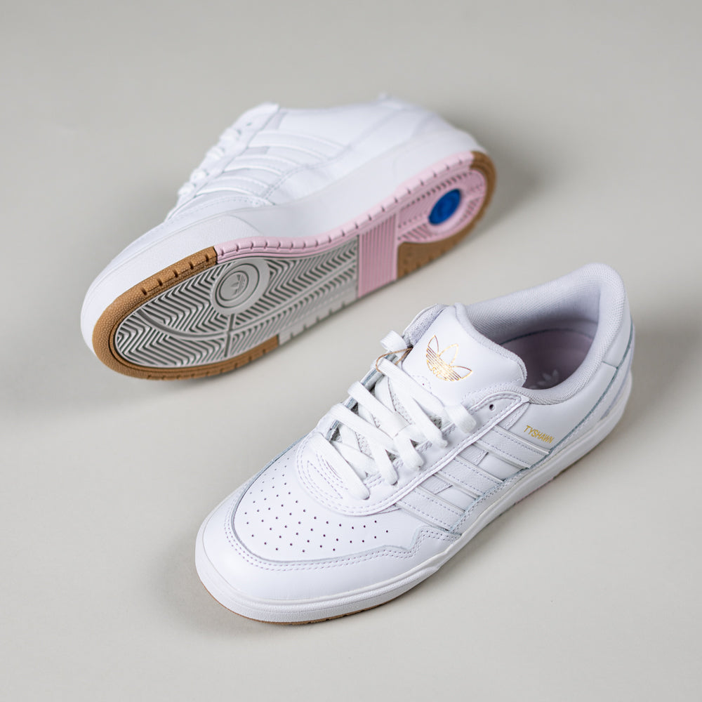 A pair of JQ1130 Cloud White Tyshawn 2 adidas leather skateboarding shoes with gum soles and gold branding—one shows the sole, the other stands upright, both on a light gray background.