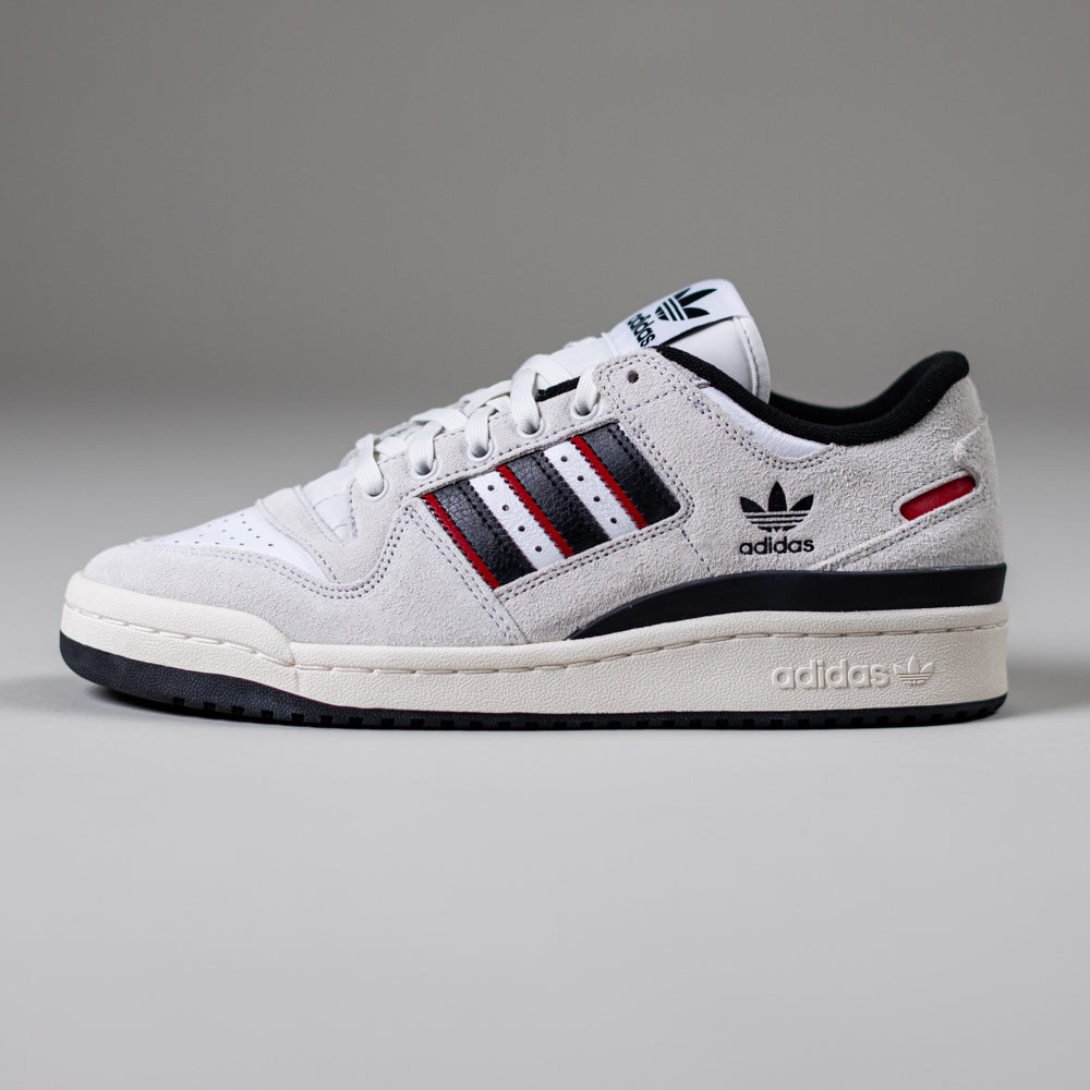 The JP6094 Cry White Core Black Forum 84 Low Adidas Skateboarding Suede Shoes feature classic three stripes and an Adidas logo on the side, with black and red accents, shown against a plain gray background.