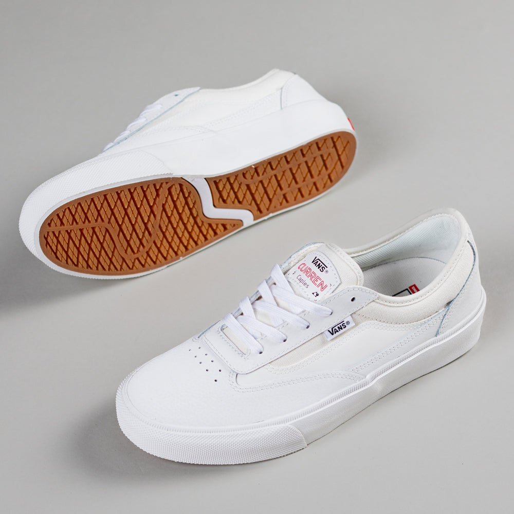 A pair of VN000D85JVY1 Skate Curren Caples Blanc de Blanc Vans shoes is shown; one upright to display the suede upper, the other on its side highlighting the vulcanized gum rubber sole designed for skateboarding.
