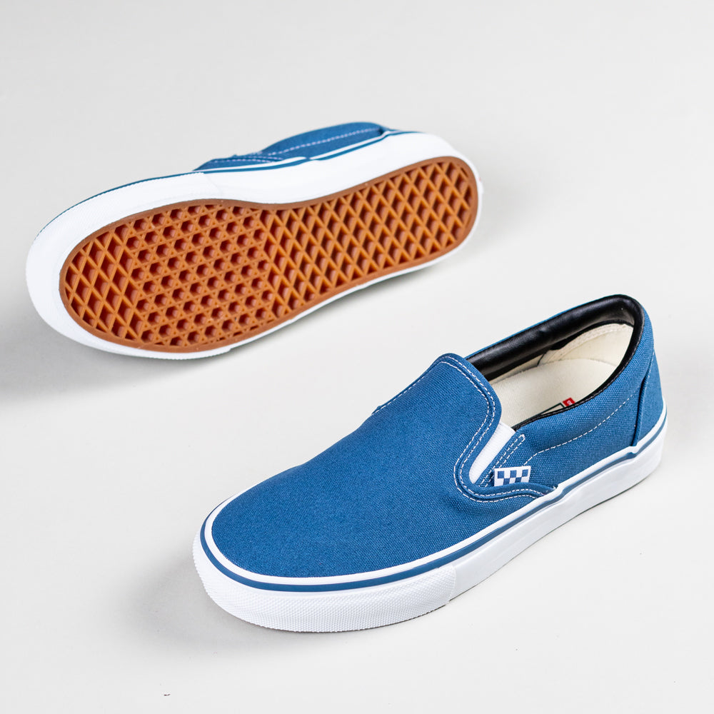 A pair of VN0A5FCANVY1 Navy Skate Slip On Vans Canvas Shoes, featuring POPCUSH cushioning, white soles, and textured brown rubber outsoles; one shoe shows top and side details, the other displays the sole.
