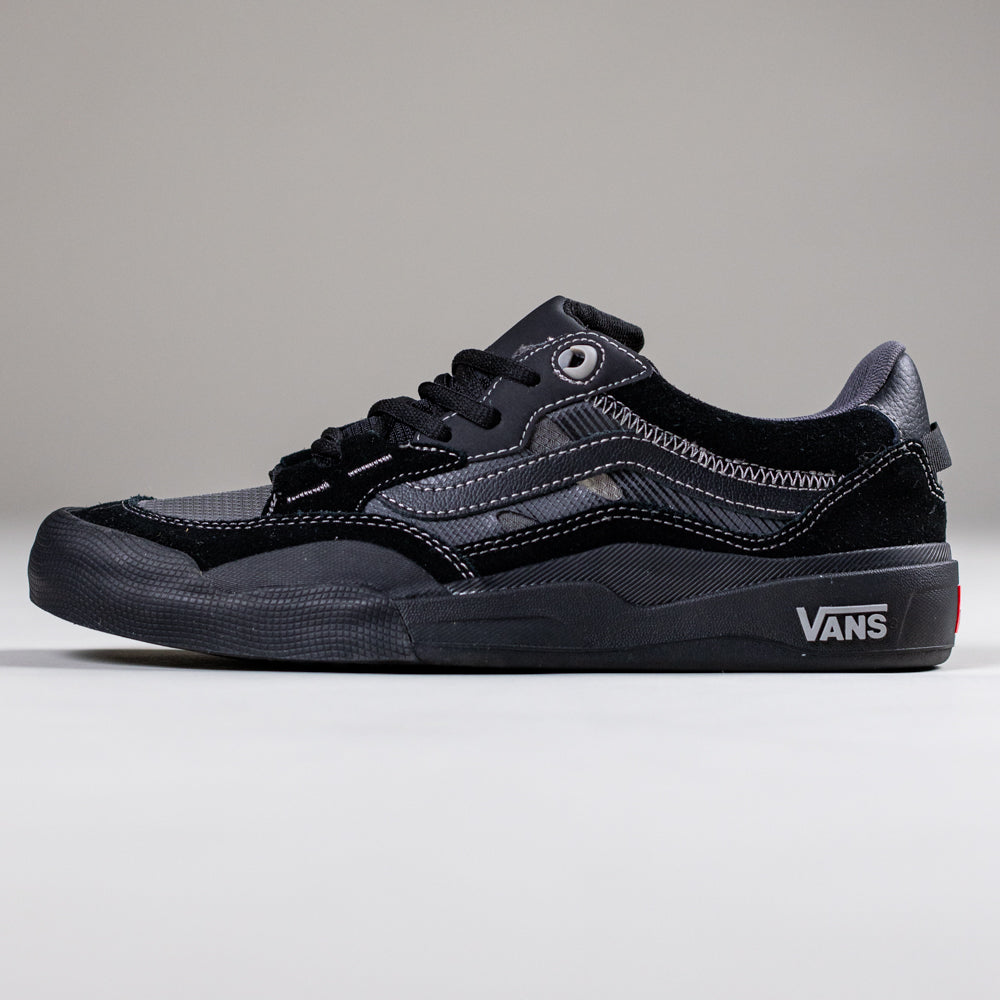 The VN000D5D1741 Wayvee Skate 2 Black Black Grey Vans suede shoe features white stitching, black laces, a rubber sole, and visible Vans logos on the heel and side. Displayed on a plain light background, it's built for durability in skateboarding.