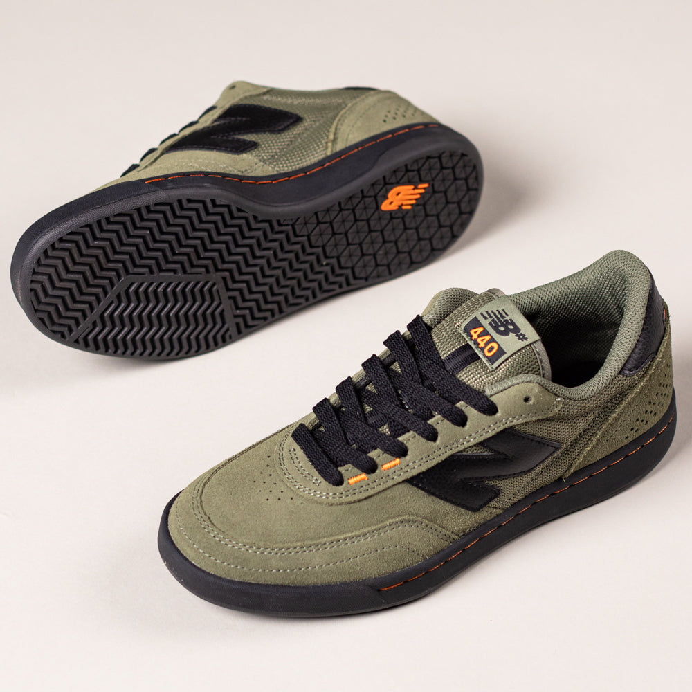 A pair of 440NL2 Dark Olivine Black New Balance Numeric suede skateboarding shoes with black soles, laces, and N logos plus orange accents—one upright, one sole-up—displayed on a light background.