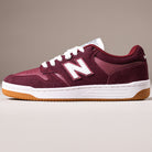 The 480PRO Monarch Burgundy New Balance Numeric Suede Skateboarding Shoe features white laces, a white “N” logo, FuelCell foam midsole, and gum rubber outsole inspired by heritage basketball shoes, set against a neutral background.