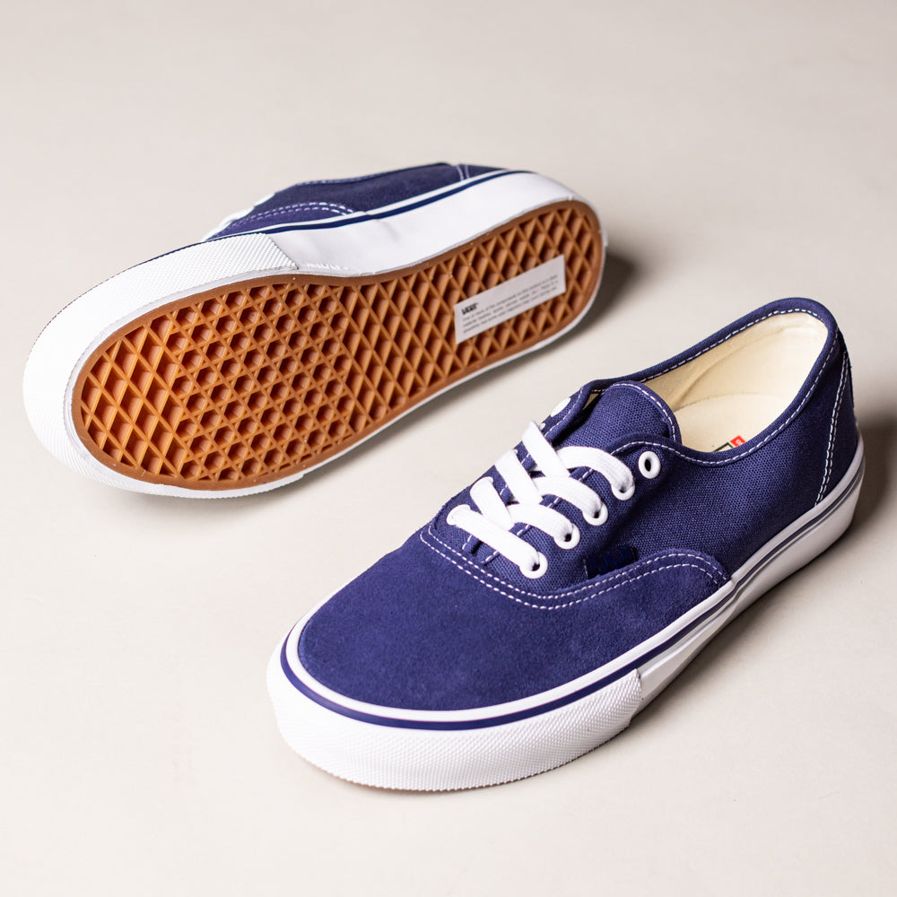 A pair of Vans Skate Authentic Deep Twilight VN000EEREMT1 suede white skateboarding shoes: one is upright, the other on its side showing the brown waffle-patterned sole. Both feature dark blue uppers, white laces, and rubber soles.
