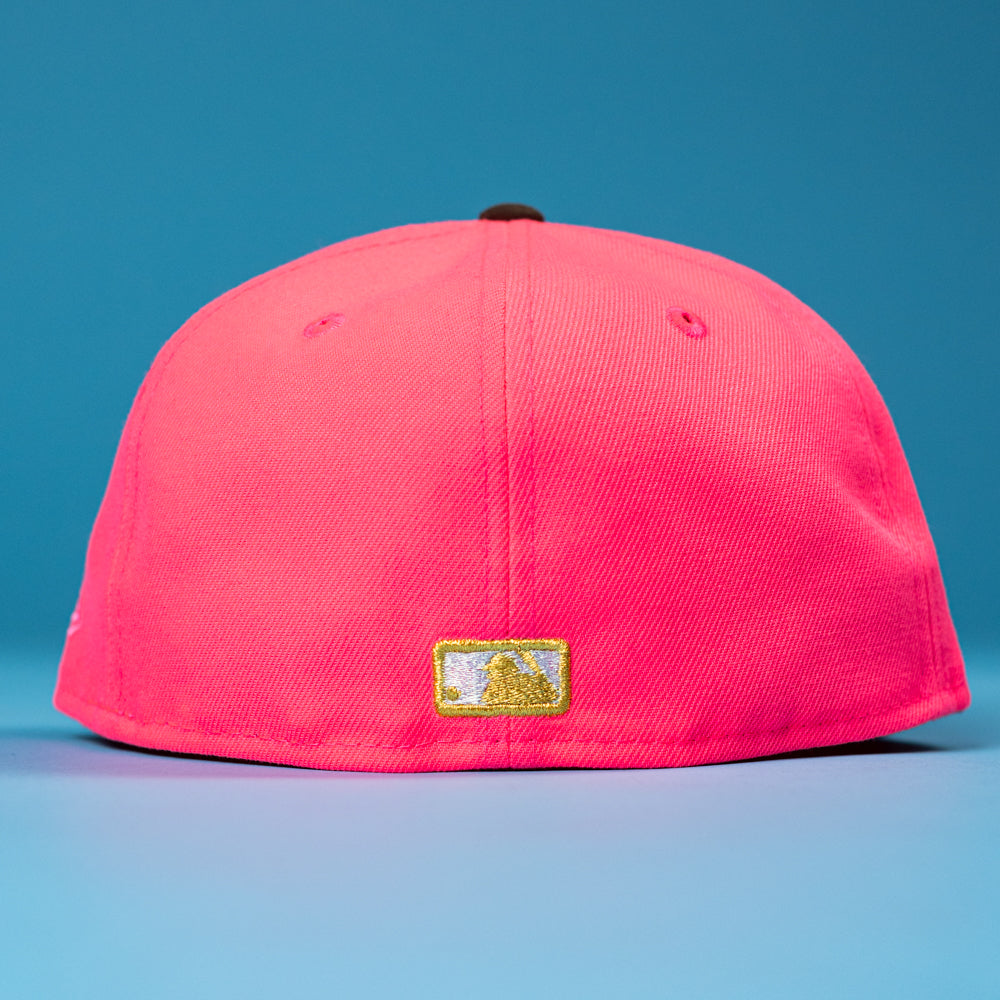 The Pink Comet WS22 Houston Astros New Era 5950 Fitted Hat is shown from the back, displaying a small gold and white embroidered logo above the bottom edge against a solid blue background.