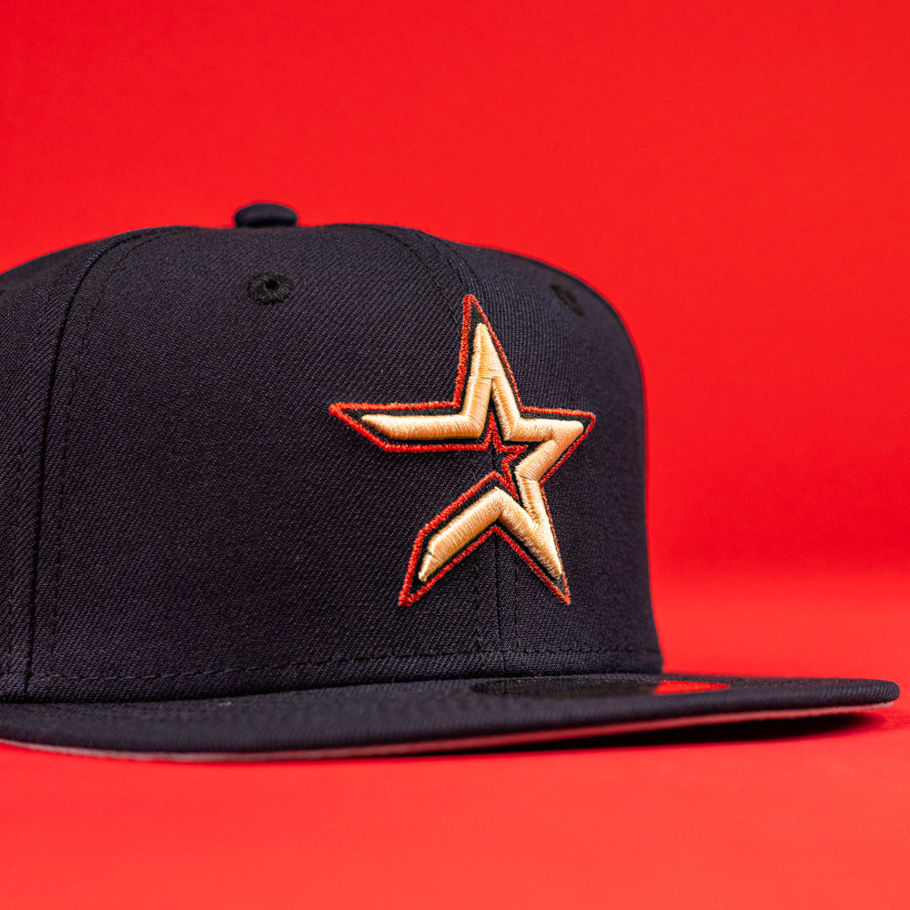 The 6am in Texas Navy Red White New Era Hat 5950 Fitted features a bold star logo embroidered in yellow and red, set on the front, and is showcased against a vibrant red background.