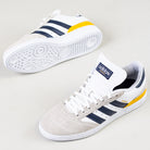 A pair of JP8604 Brown Navy Busenitz Adidas Skateboarding Suede Shoes featuring brown suede uppers, navy stripes, white soles, and yellow heel accents. One shoe is upright, the other shows the sole.