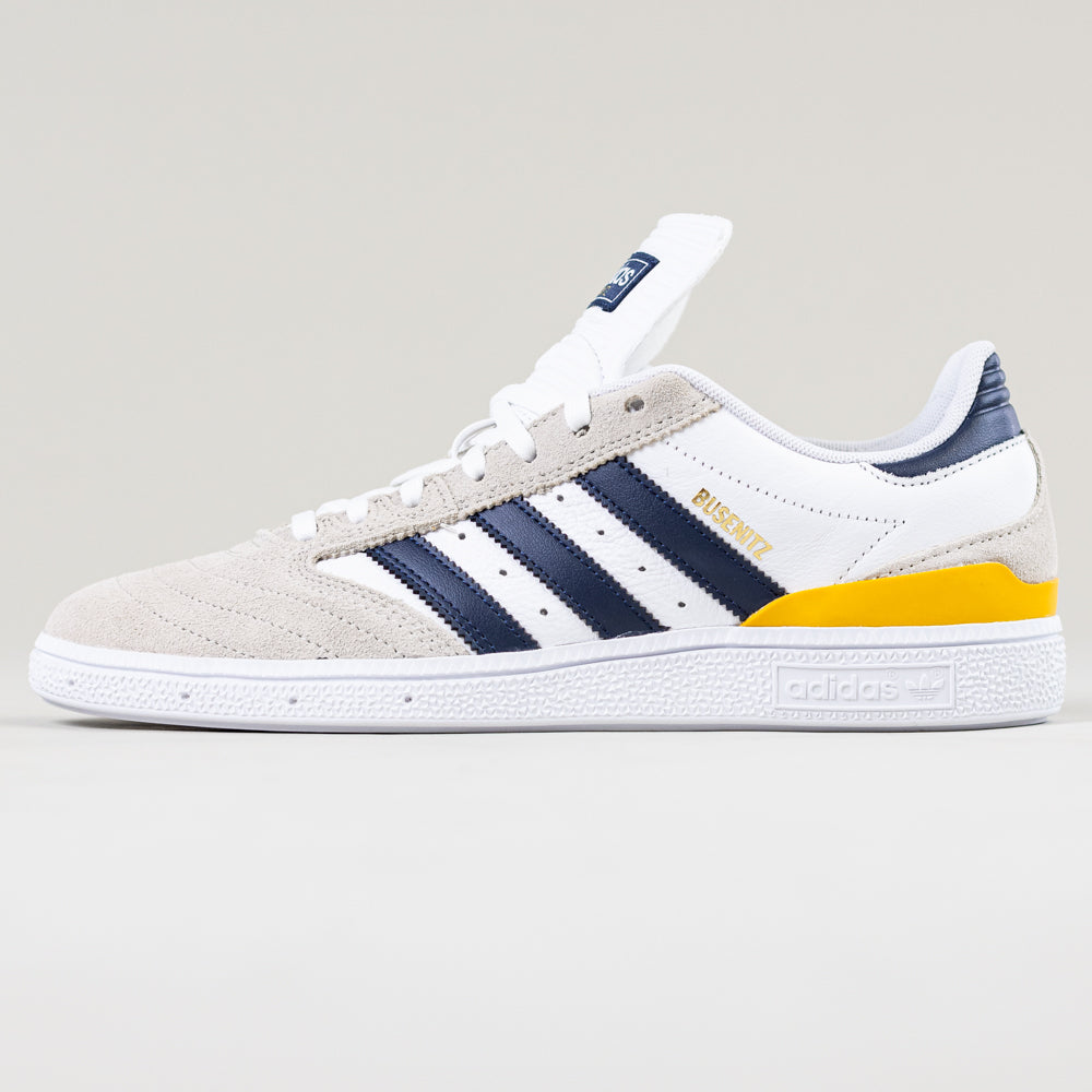 A brown JP8604 Busenitz Adidas skateboarding shoe with a suede upper, navy stripes, and gold BUSENITZ branding, displayed on a plain light background.