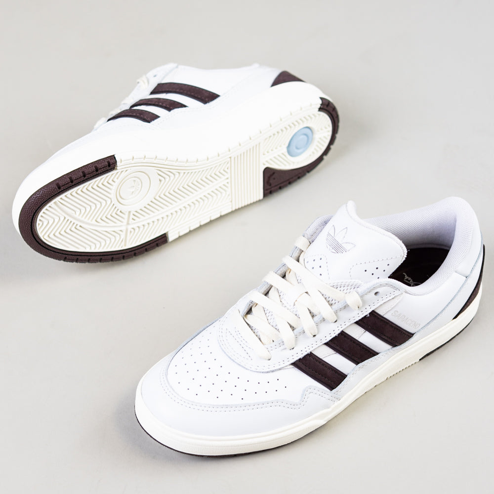 A pair of JQ1620 Crystal White Brown Zach Saraceno Tyshawn 2 II Adidas Skateboarding Shoes is shown with one upright to reveal the top and side, and the other on its side to display the sole. The premium leather shoes rest on a light gray background.