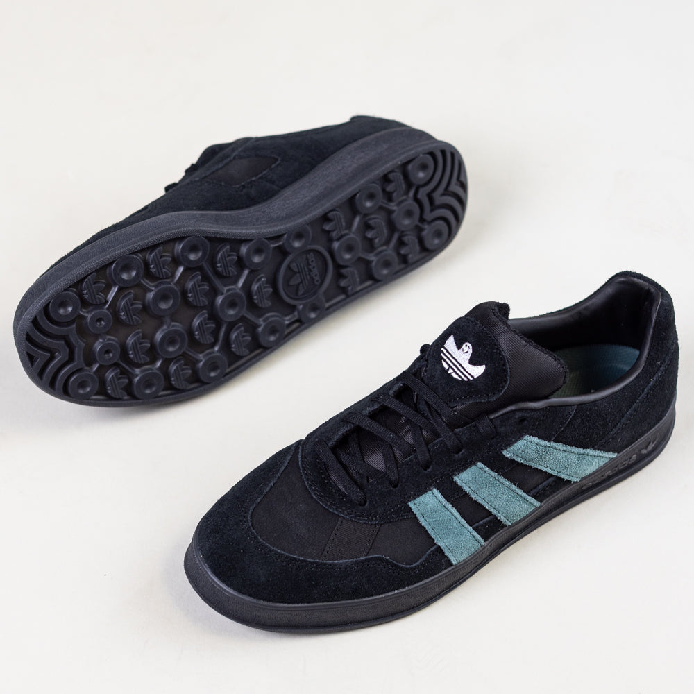 The JQ1042 Black Prete Aloha Super Suede Leather Skateboarding Shoes by Adidas feature teal stripes and textured black soles, shown on a white background with one top-down view and one sole highlighting board control.