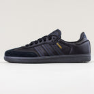 The JR2059 Black Black Samba ADV Adidas Skateboarding Shoes feature black leather and suede, dark blue suede accents, three black stripes, a molded sockliner, and "SAMBA" in gold on the side, shown on a white surface with a light background.