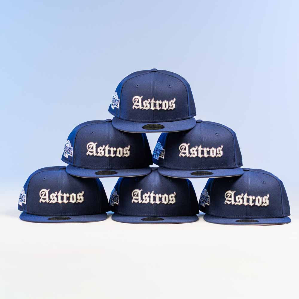 Six Fat Elvis OE ASG Dark Blue New Era Hat 5950 Fitted caps are arranged in a pyramid shape, with "Astros" on the front, set against a light blue background.