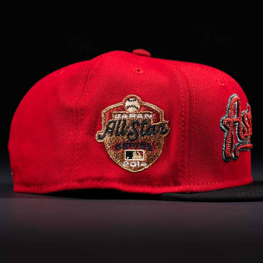 The Samurai Japan ASG Houston Astros New Era Hat 5950 Fitted features a gold and black 2014 MLB All-Star Game patch on the side. Shown against a dark background, it’s perfect for Houston Astros fans.