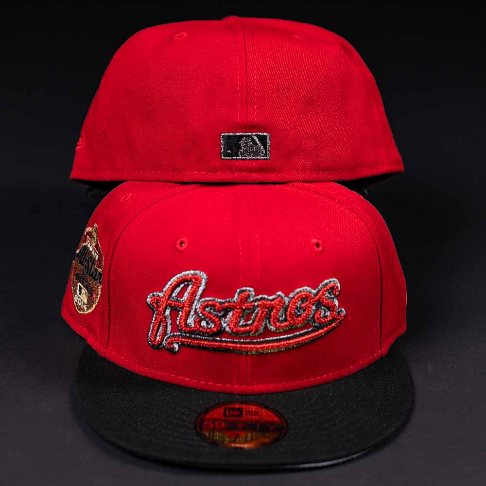 Two Samurai Japan ASG Houston Astros New Era Hat 5950 Fitted caps with red crowns and black brims are displayed. The front shows the team logo and commemorative patch; the back features a small MLB logo, all set against a dark background.
