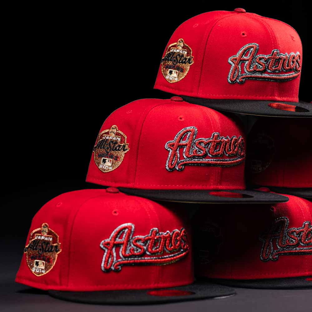 Four Samurai Japan ASG Houston Astros 5950 Fitted New Era Hats with black brims are stacked. Each cap displays a bold logo and side patch in striking red, white, and black embroidery.
