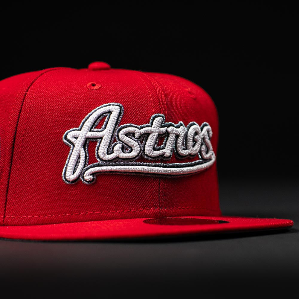 The Sunnyside Bo Bundy WS05 Houston Astros New Era 5950 Fitted Hat features "Astros" in white script on a red cap, displayed against a black background.