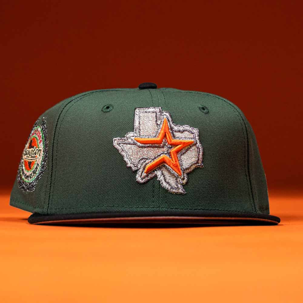 The El Jager Mountain Orange New Era Hat 5950 Fitted features a green design with an embroidered Texas outline and orange star on the front, set against an orange background—perfect for showcasing your state pride in style.