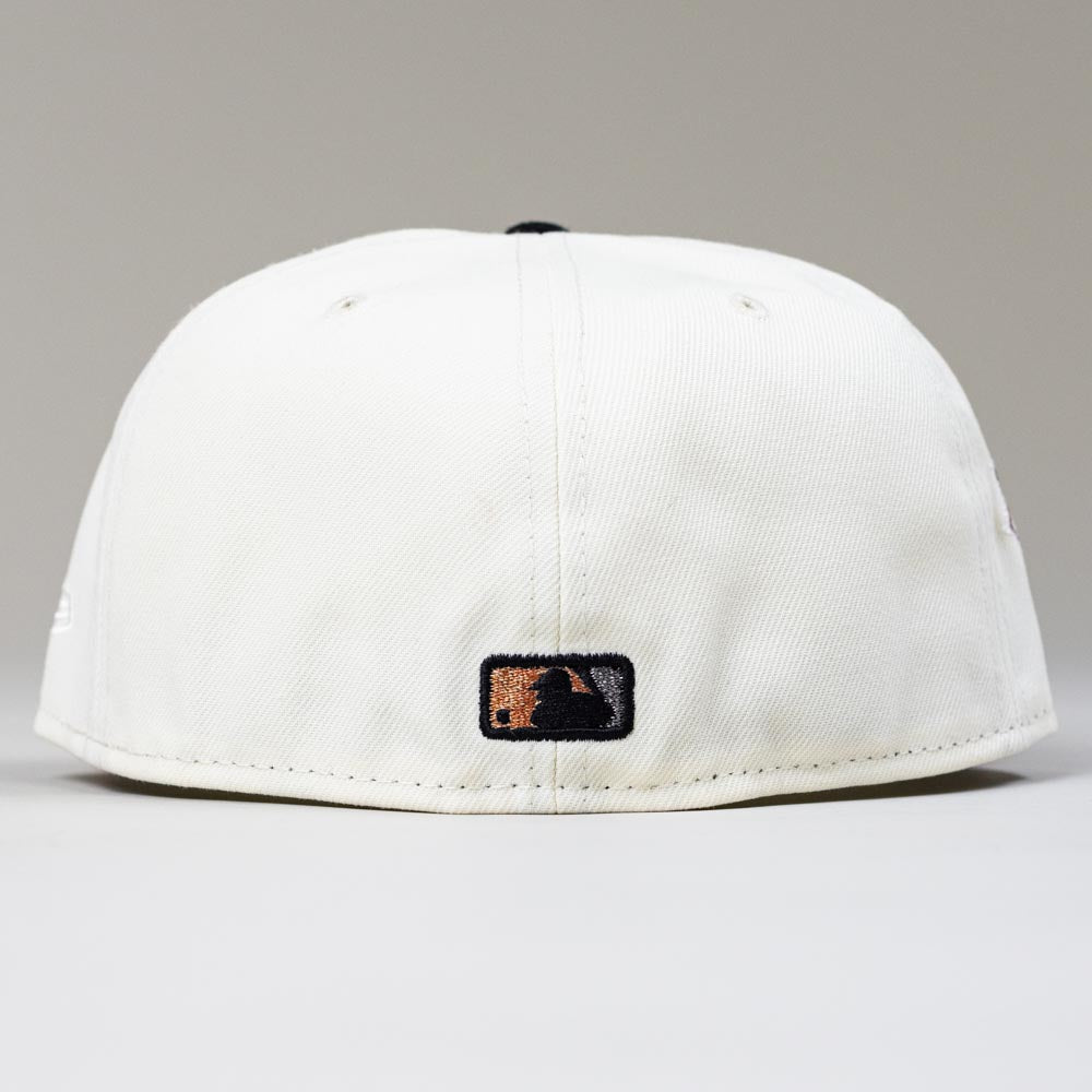An Orange Soda WS22 Houston Astros 5950 Fitted New Era Hat is shown from the back, highlighting a small black and gold MLB logo near the bottom edge against a plain light gray background.