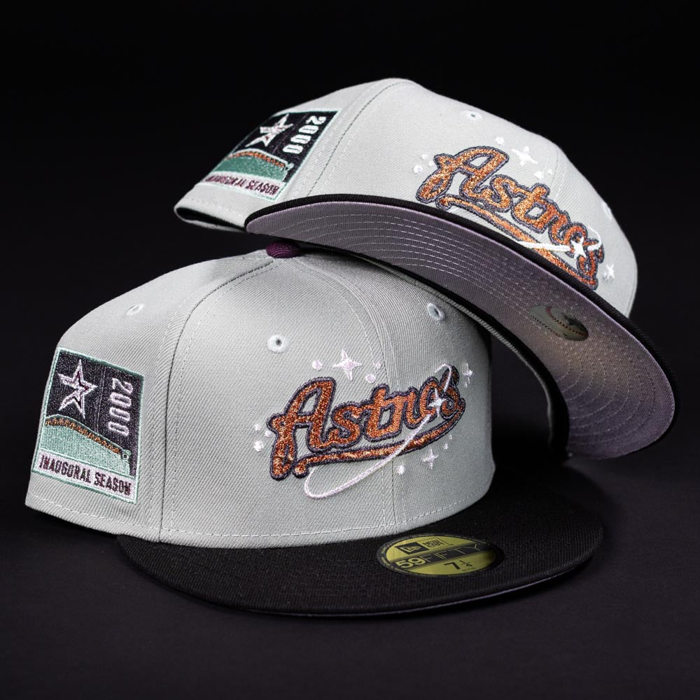 Two Pixie Dust New 2000 Houston Astros New Era Hat 5950 Fitted caps, in gray and black with the Astros logo and a 2000 inaugural season patch, are displayed against a black background.