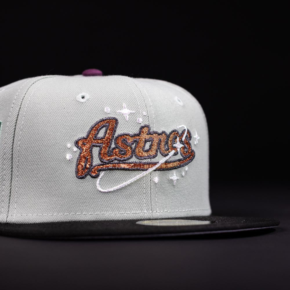 The Pixie Dust New 2000 Houston Astros New Era Hat 5950 Fitted is grey with a black brim, featuring an orange and brown Astros logo with a white orbit and stars embroidered on the front—a must-have for fans.