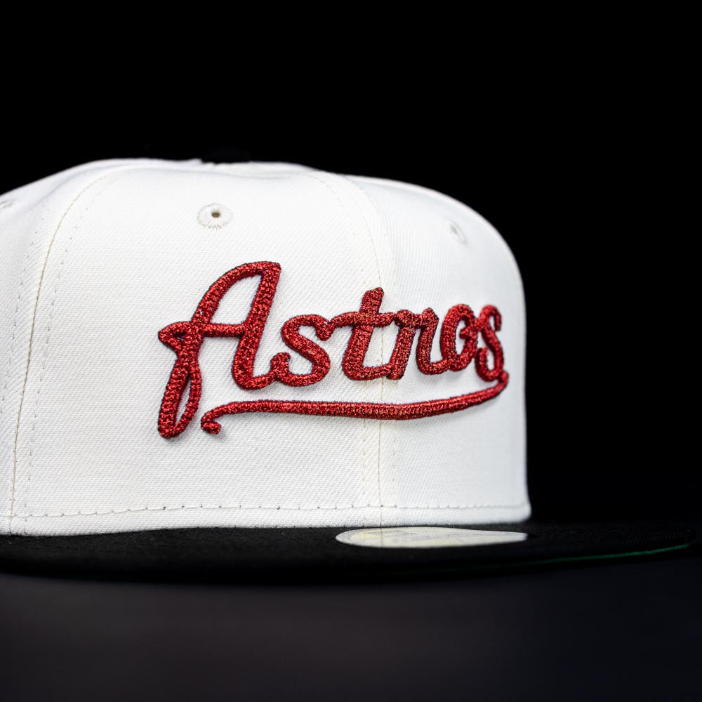 The Red Soda New Era HOF Red Black Chrome Houston Astros 5950 Fitted Hat features "Astros" in red script on a black and white design—a perfect pick for Houston Astros fans.