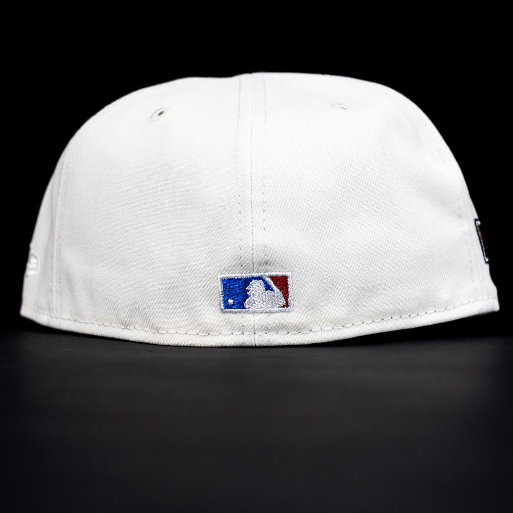The Red Soda New Era HOF Red Black Chrome Houston Astros 5950 Fitted Hat is shown from the back, featuring the MLB logo embroidered above the bottom edge, set against a black background.