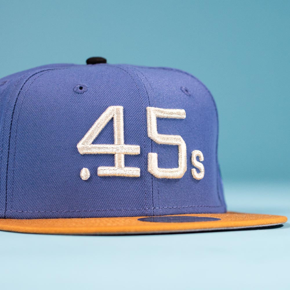 The Harbor Mark Canvas Houston Astros New Era 5950 Fitted Hat features a blue design, yellow brim, and white embroidered .45s text on the front—perfect for fans and collectors. Displayed against a light blue background.