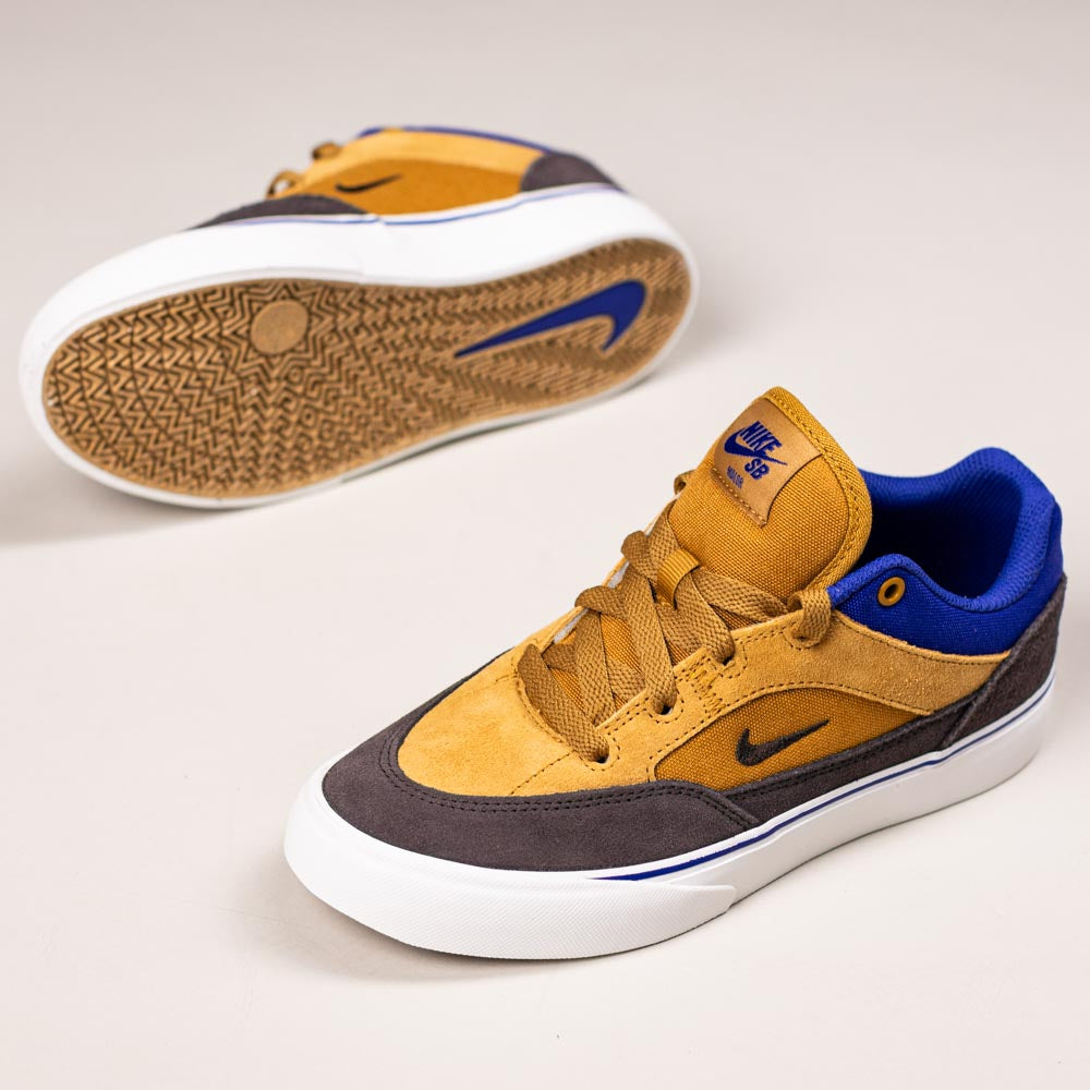 The HF1205700 Wheat Velvet Brown Deep Night YOUTH Malor GS Nike SB Shoes feature durable mustard yellow, brown, and blue uppers with white soles and blue logos—one shoe upright, the other showing its textured sole. Perfect for kids’ skate needs.