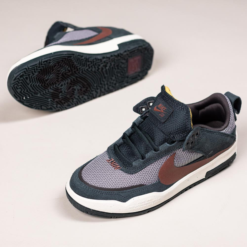 A pair of FN4210-302 Seaweed Red Sepia Medium Ash YOUTH Day One GS Nike SB Shoes with dark blue, brown, and gray mesh and suede uppers, white midsoles, and black patterned outsoles featuring a Zoom Air unit, displayed on a light background.