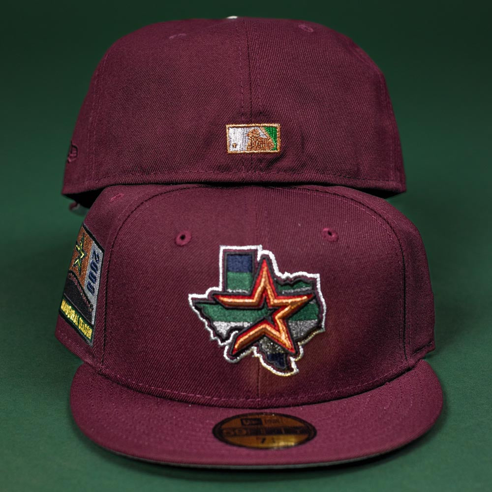 Two Pinkerton 2.0 Rushmore 2000 Maroon Houston Astros New Era 5950 Fitted hats are shown: the front hat has a Texas outline with star and Astros logo, side patch; the back displays a small embroidered Texas flag patch.