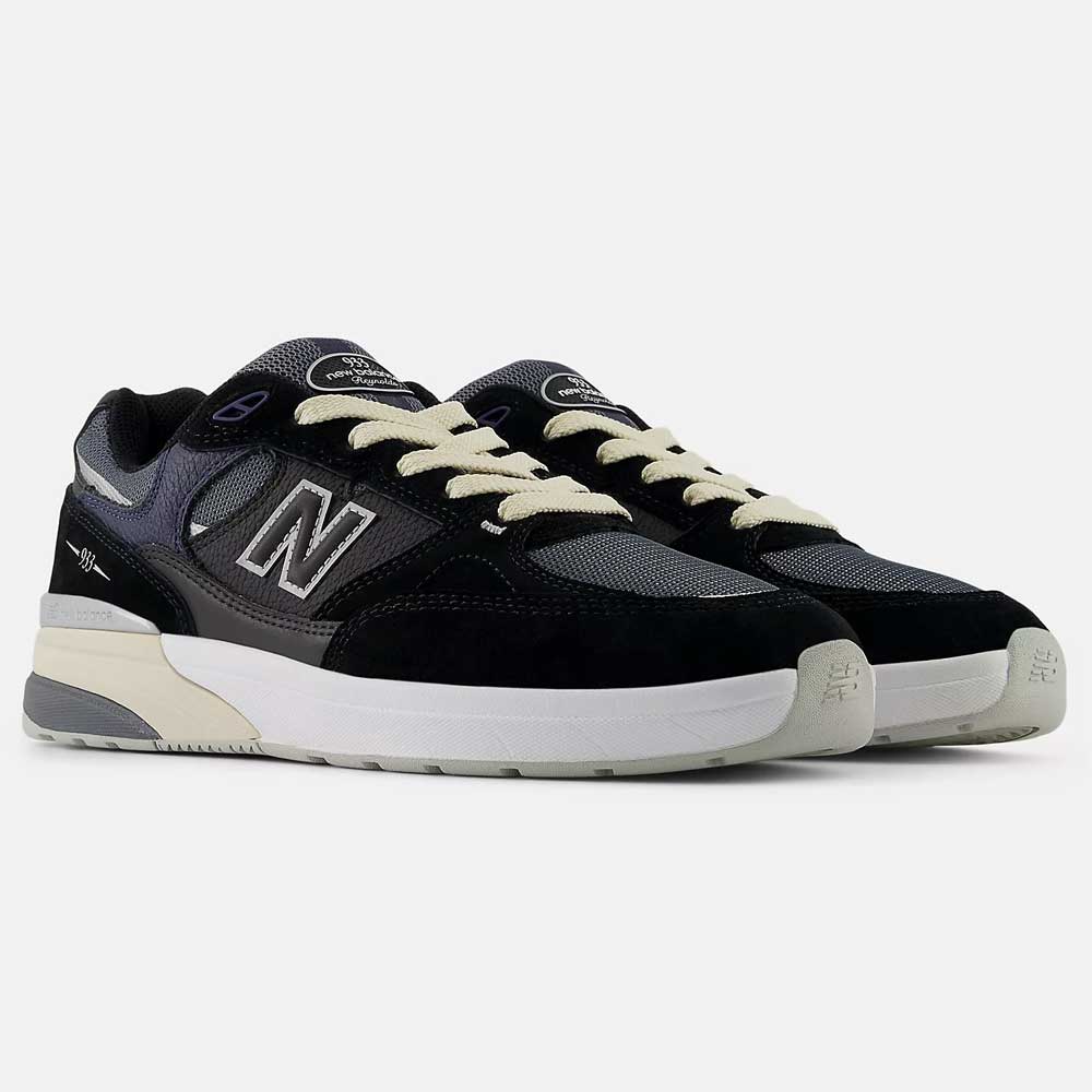 The Black Eclipse 933 BNT Andrew Reynolds New Balance Numeric Suede Skateboarding Shoes feature black, grey, and white color blocking, ABZORB cushioning, a bold N logo, white laces, and a chunky white and grey sole on a plain background.
