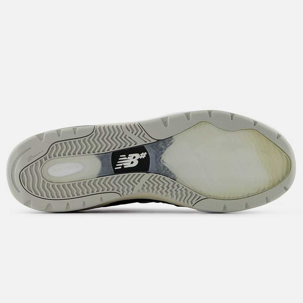 The image shows the sole of a Black Eclipse 933 BNT Andrew Reynolds New Balance Numeric Suede Skateboarding Shoe. The light gray outsole has textured tread for grip, with a black center section featuring a white New Balance logo.