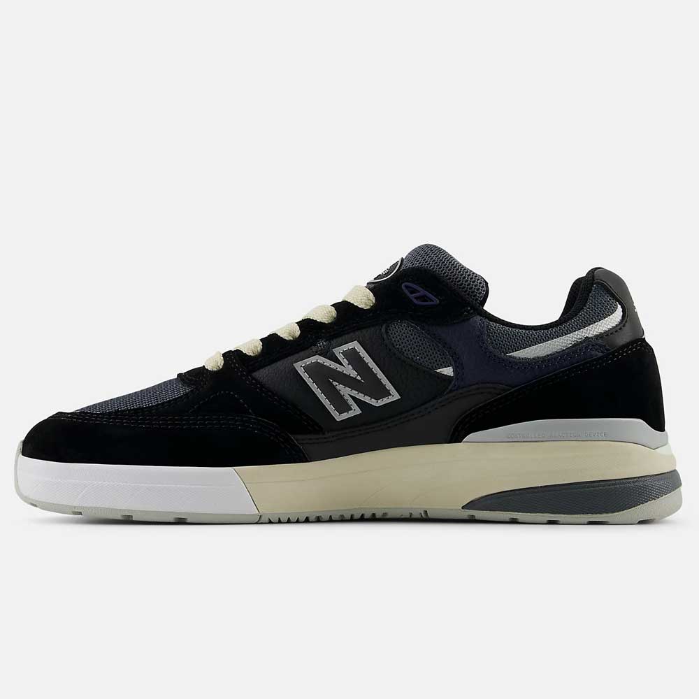 The Black Eclipse 933 BNT Andrew Reynolds New Balance Numeric suede skateboarding shoes feature a black and dark gray suede and mesh upper, ABZORB-cushioned white midsole, beige outsole, and side N logo, shown in side profile on a plain background.