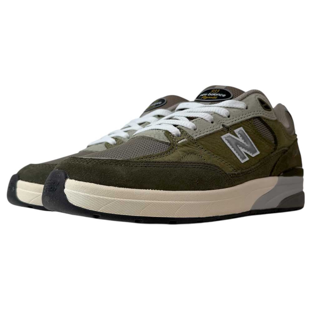 The 933 JKL Andrew Reynolds Grey Day New Balance Numeric Skateboarding Shoes feature an olive green and gray suede upper, white laces, cream midsole, and black rubber outsole—designed for durability.