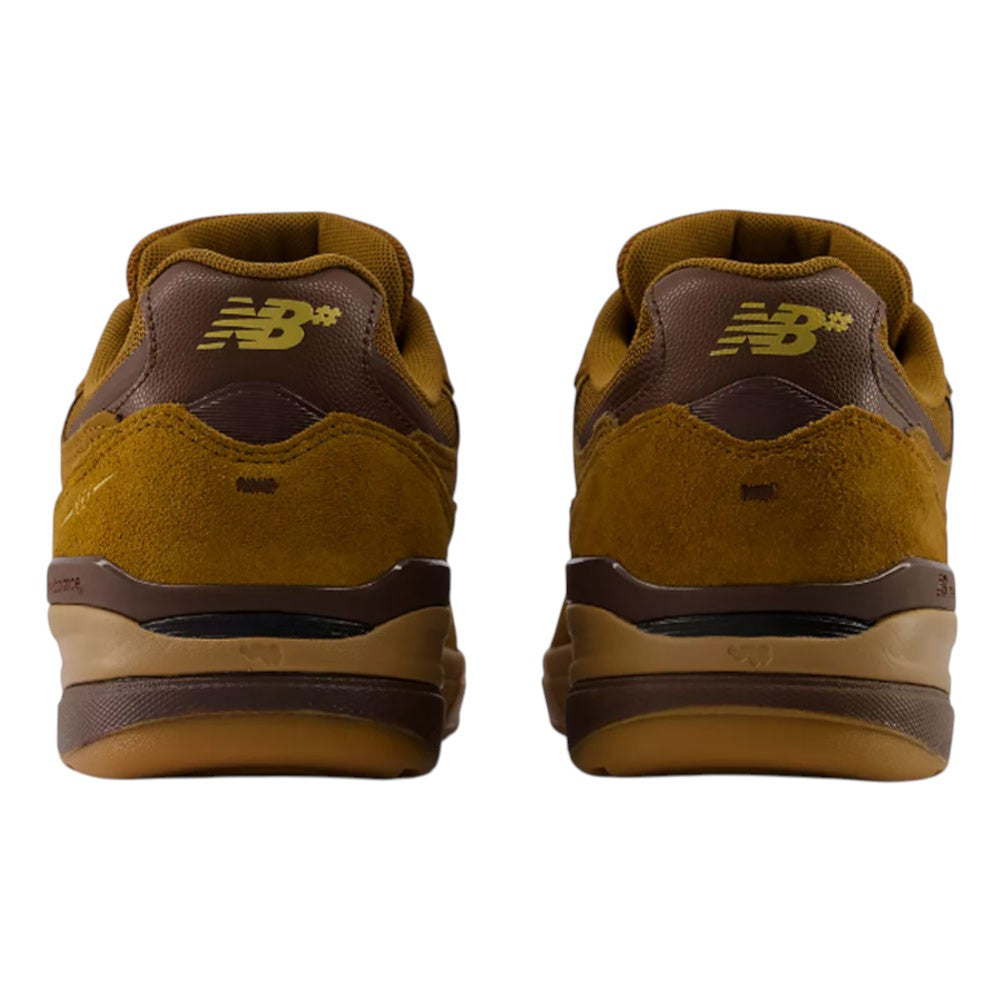 Rear view of a pair of brown and mustard yellow 933 LRO Andrew Reynolds New Balance Numeric Suede Skateboarding Shoes, featuring suede and leather details with the New Balance logo on the heel. Inspired by heritage NB running shoes, this design blends classic style with modern comfort for skateboarding.