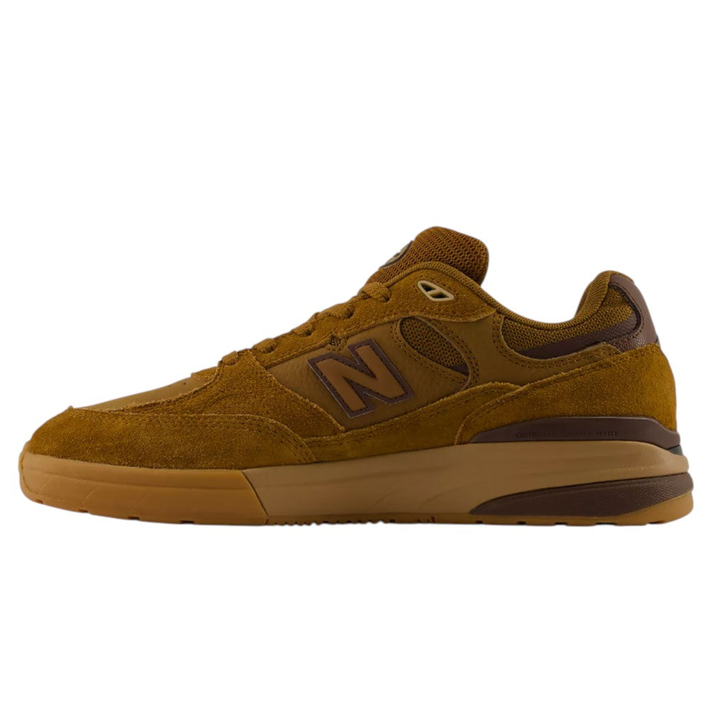 A left-side profile of the WIDE 933 LRO Andrew Reynolds New Balance Numeric Suede Skateboarding Shoe is shown against a white background. This brown and tan sneaker features suede and mesh materials, a thick rubber sole, and the iconic “N” logo on the side. It is enhanced with an ABZORB midsole for superior cushioning.