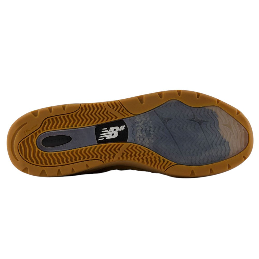 Brown and black rubber sole of the WIDE 933 LRO Andrew Reynolds New Balance Numeric Suede Skateboarding Shoe, showcasing the New Balance logo at the center and a multi-textured grip pattern for superior traction—perfect for fans of Andrew Reynolds-inspired footwear.