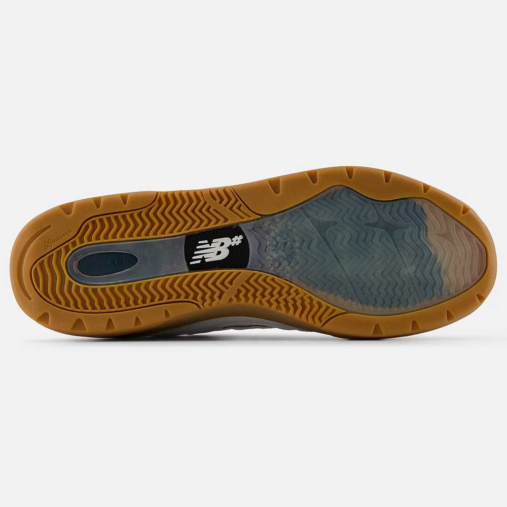 Close-up of the 933 WWB White Black Andrew Reynolds New Balance Numeric Suede Skateboarding Shoe sole, showing a tan rubber edge, wavy tread, semi-transparent area, and a black-and-white New Balance logo at the midfoot.