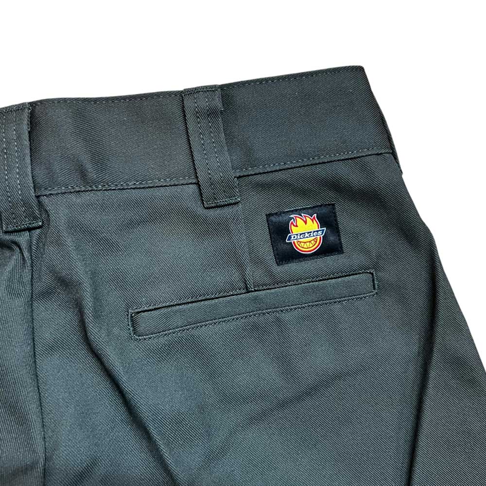 Close-up of olive A865R0OG Spitfire Double Knee Dickies Skateboarding Pant in regular fit twill, showing a back pocket and a rectangular Dickies logo patch with a flaming crown and yellow smiley face above the pocket.