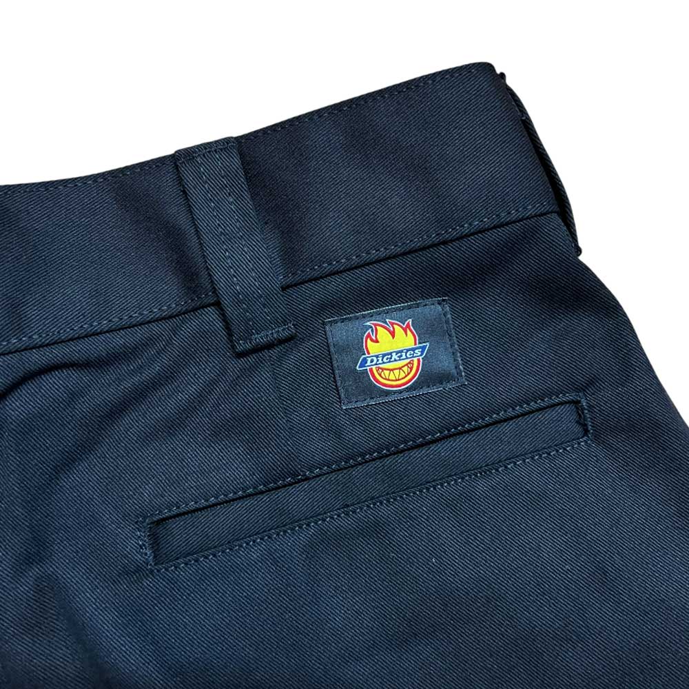 Close-up of A865SBLK Black Spitfire Flannel Cuffed Dickies Skateboarding Pant, regular fit twill, with belt loop, back pocket, and a square patch above the pocket featuring the Dickies logo with flame design.