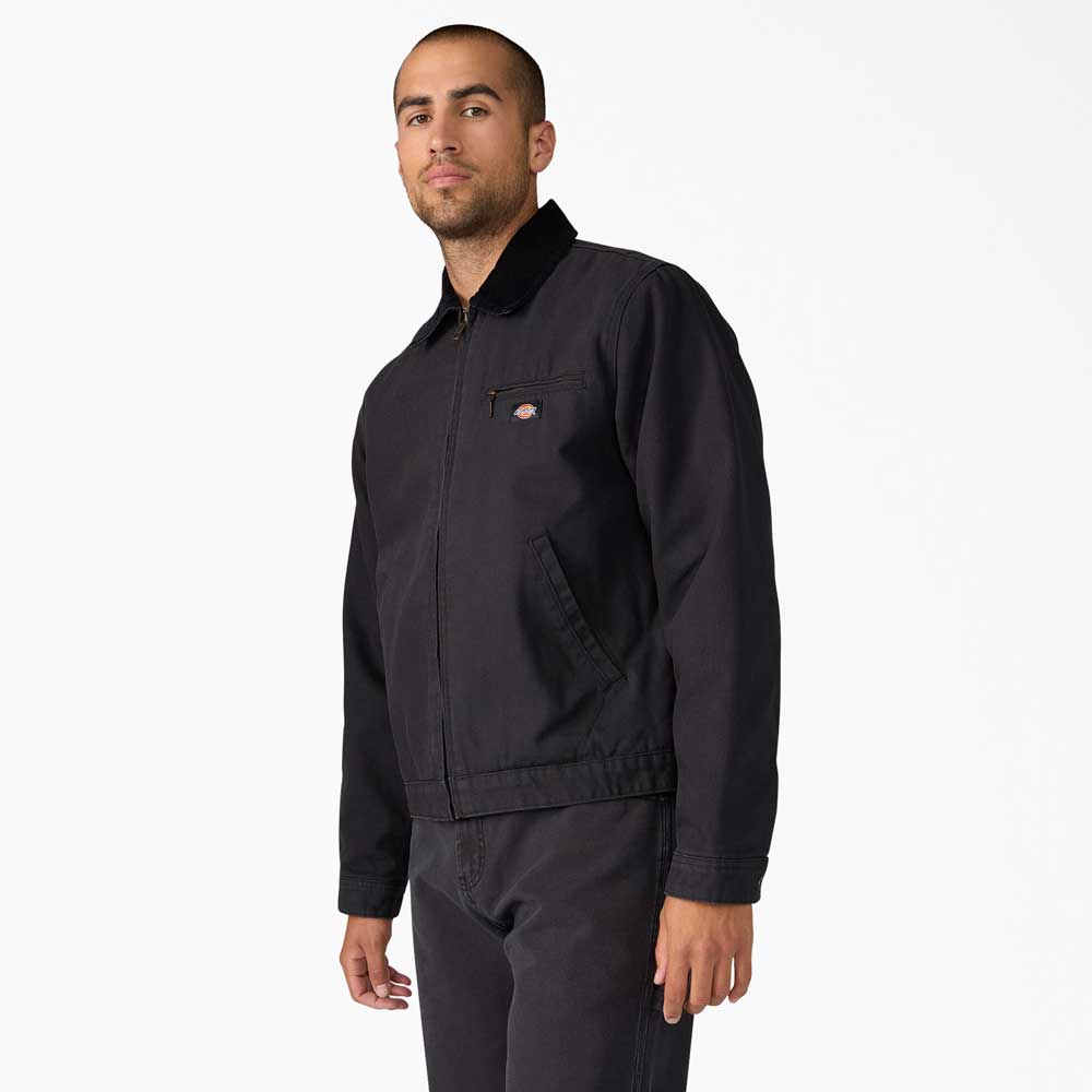 Man wearing the A8702 Black Blanket Lined Painter Canvas Jacket by Dickies Skateboarding and black pants, standing with one arm relaxed at his side, looking confidently at the camera against a plain white background.