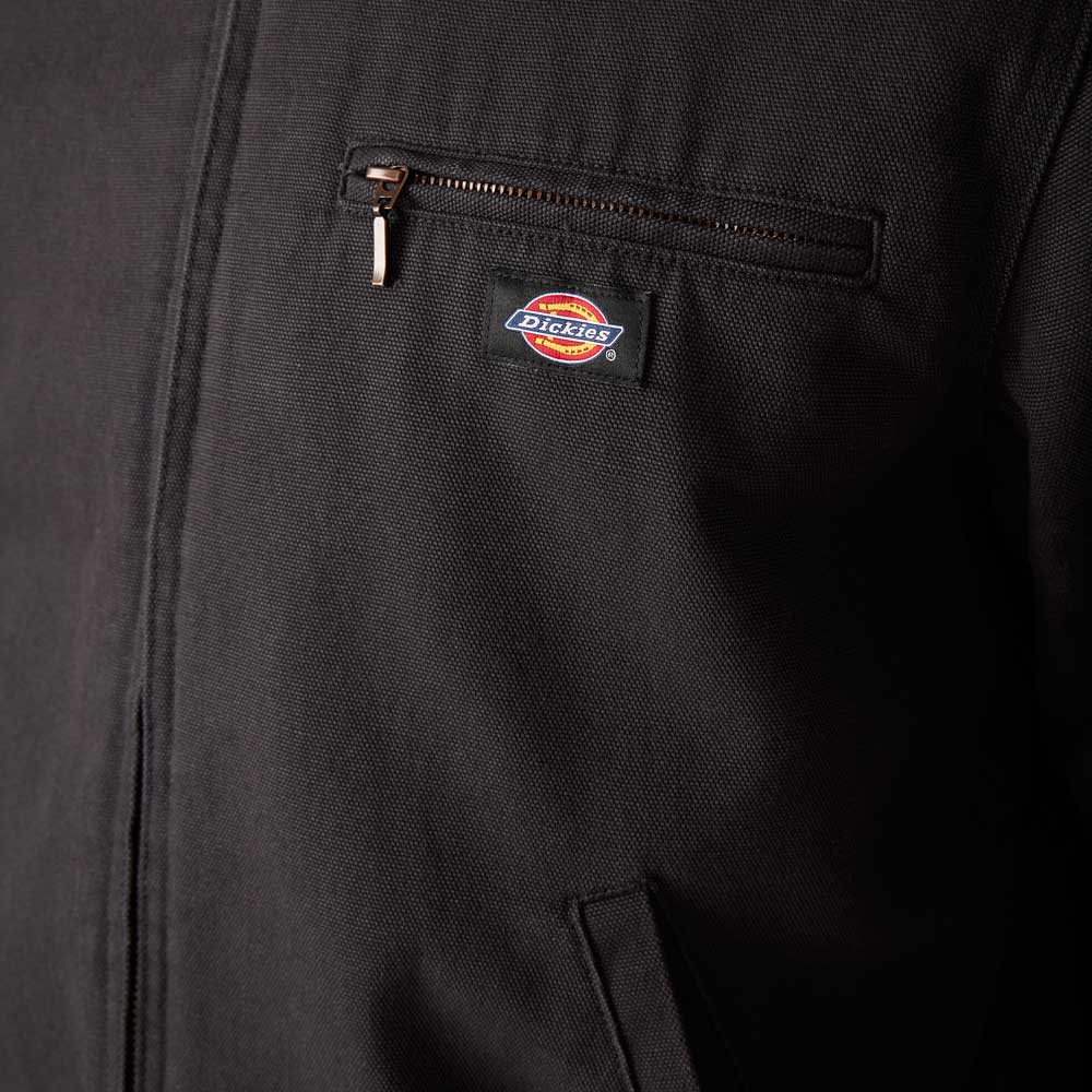 Close-up of the Dickies Skateboarding A8702 Black Blanket Lined Painter Canvas Jacket, featuring a zippered chest pocket and the Dickies logo tag above the pocket.