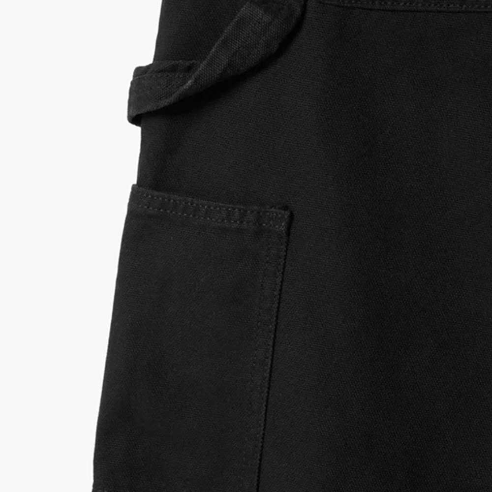 Close-up of a black fabric garment shows a rectangular stitched pocket and a loop above it, features of the A87PE Black Double Knee Canvas Carpenter Pant from Dickies Skateboarding, designed for durable, utility-focused workwear.