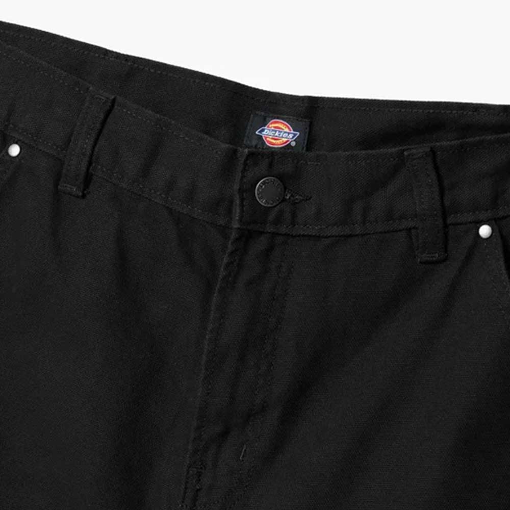 Close-up of the waistband and button on Dickies Skateboarding A87PE Black Double Knee Canvas Carpenter Pant, featuring belt loops, silver rivets, and a visible Dickies label inside.