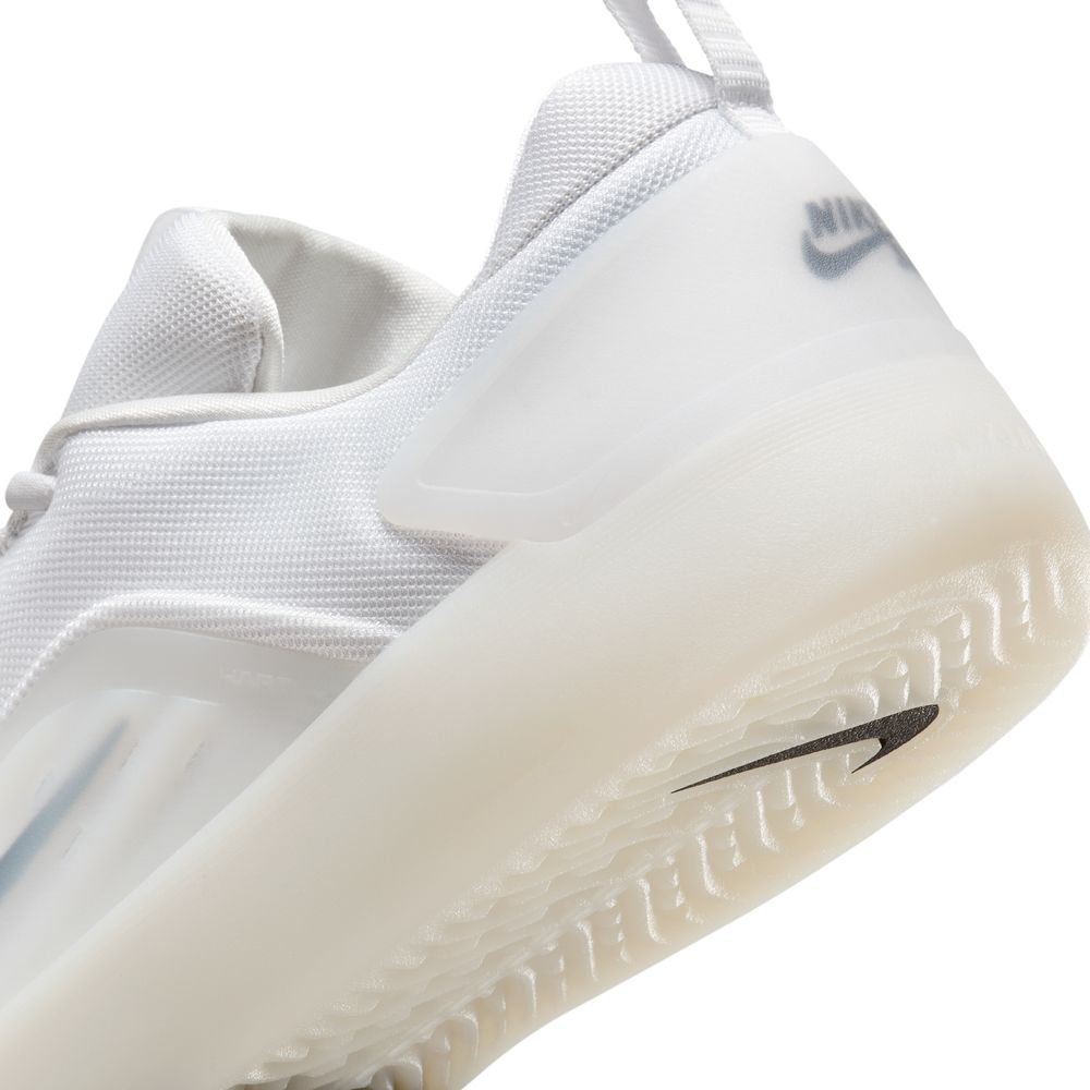 Close-up of the heel and sole of the FQ1273100 White Black Zoom Nyjah 4 Nike SB Skateboarding Shoe, showing the textured tread, HART outsole, semi-translucent rubber design, and Nike logo on the back heel tab.