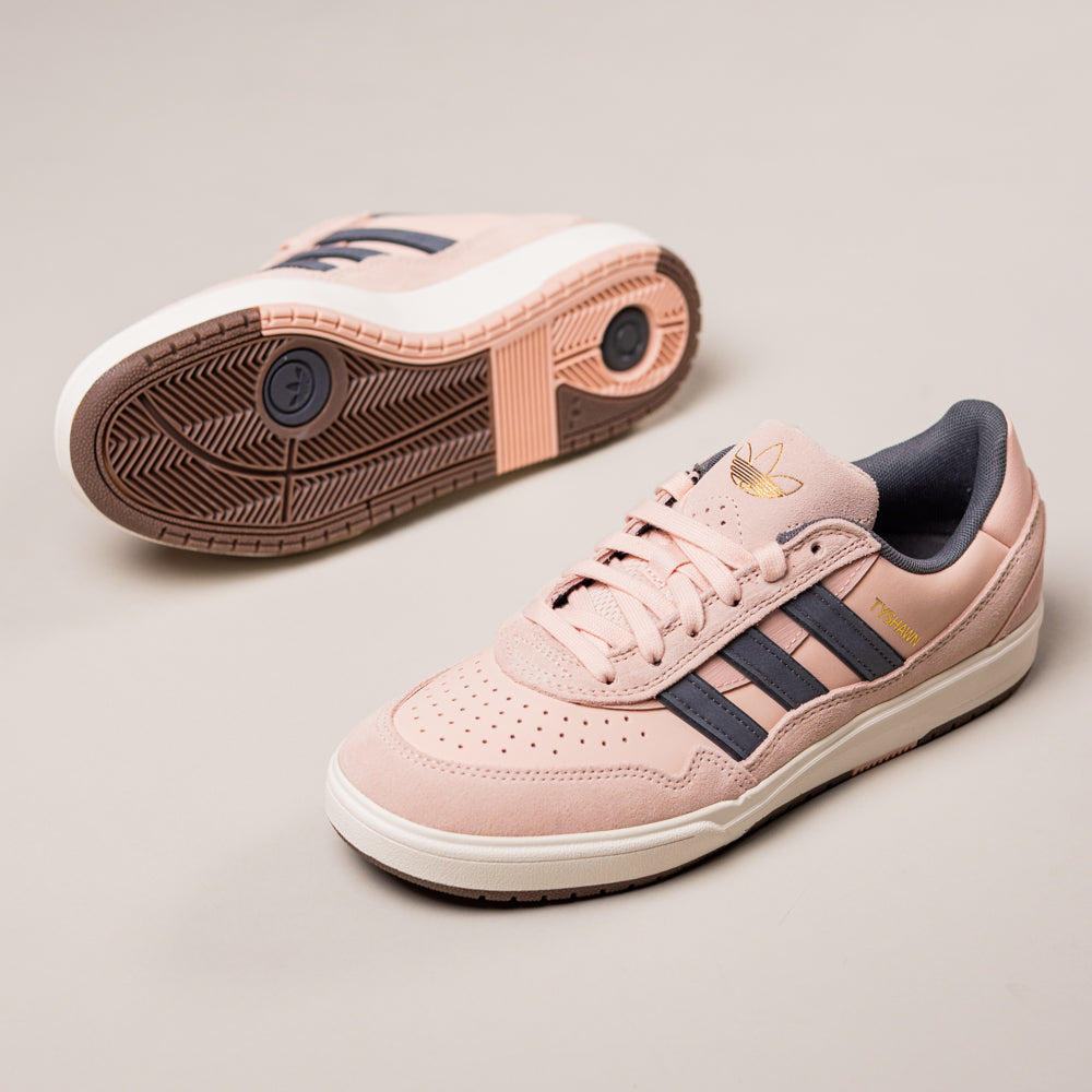 A pair of Tyshawn 2 II Pink Green HQ4733 adidas skateboarding shoes, featuring black stripes, white soles, and gold adidas branding—one upright and one on its side to showcase the tread pattern.