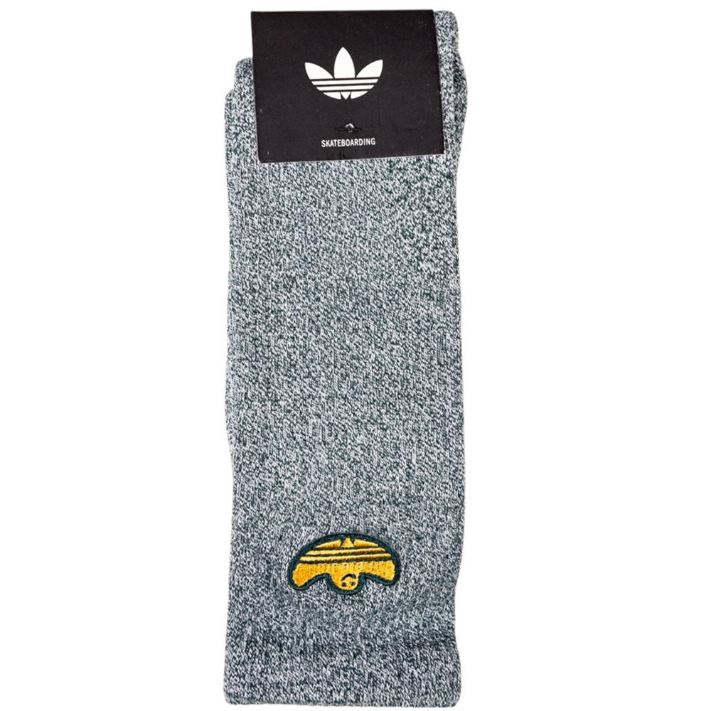 The Adidas Gonz Art Sock KD3674 is a gray skateboarding sock featuring a small yellow embroidered taco graphic and comes packaged with a black and white Adidas logo.