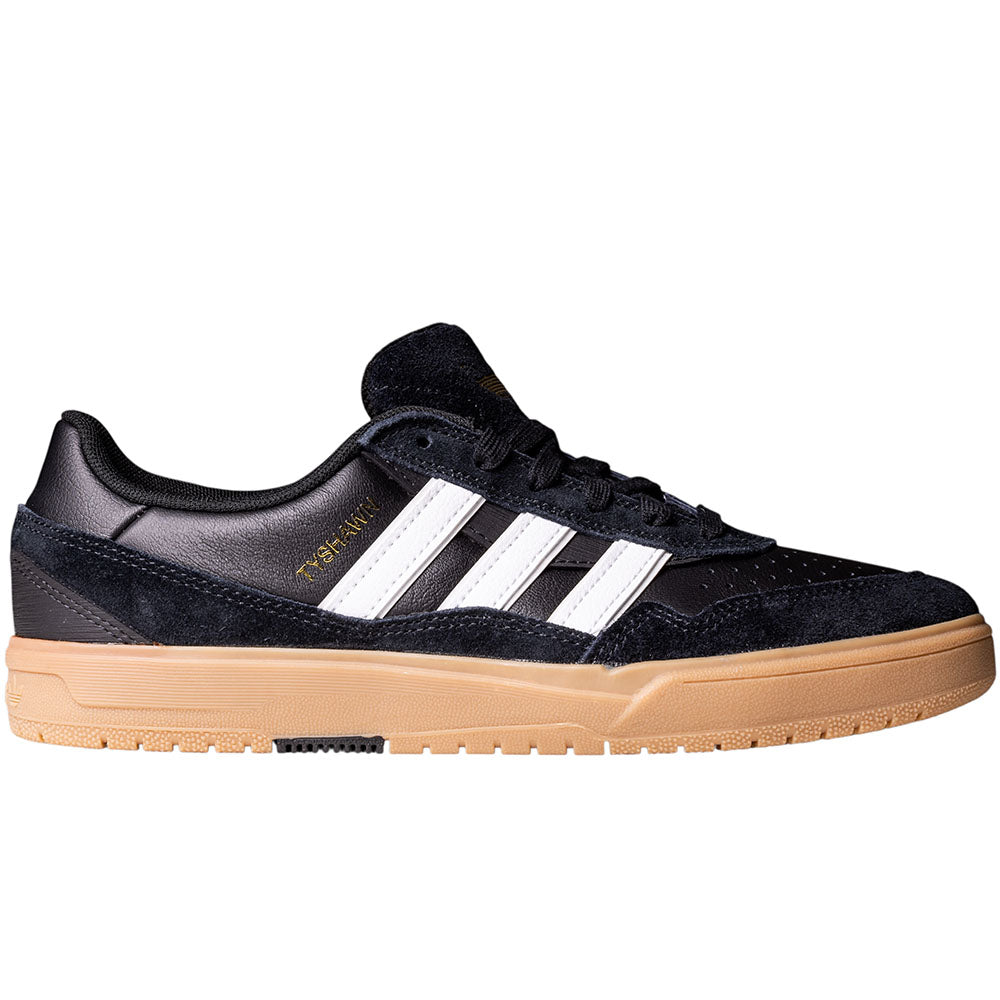 The Adidas Tyshawn 2 II HQ4734 Skateboarding Shoes are shown in side view, featuring a black low-top design, white stripes, gold text, black laces, tan rubber sole, and Lightstrike midsole on a white background.