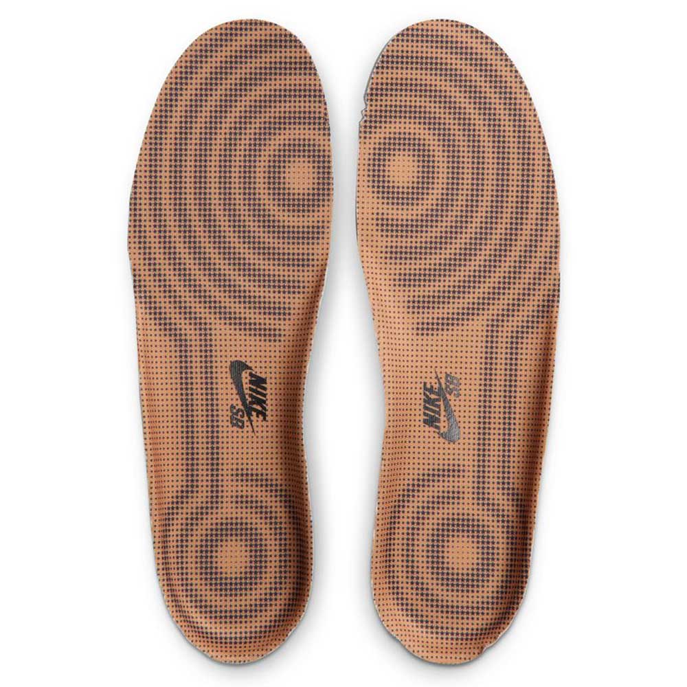 A pair of brown Nike SB insoles with black concentric circles, designed for the Air Force 1 Flax Black Gum Light Brown HM8517200 Suede Skateboarding Shoes, featuring a black Nike SB logo near the heel.
