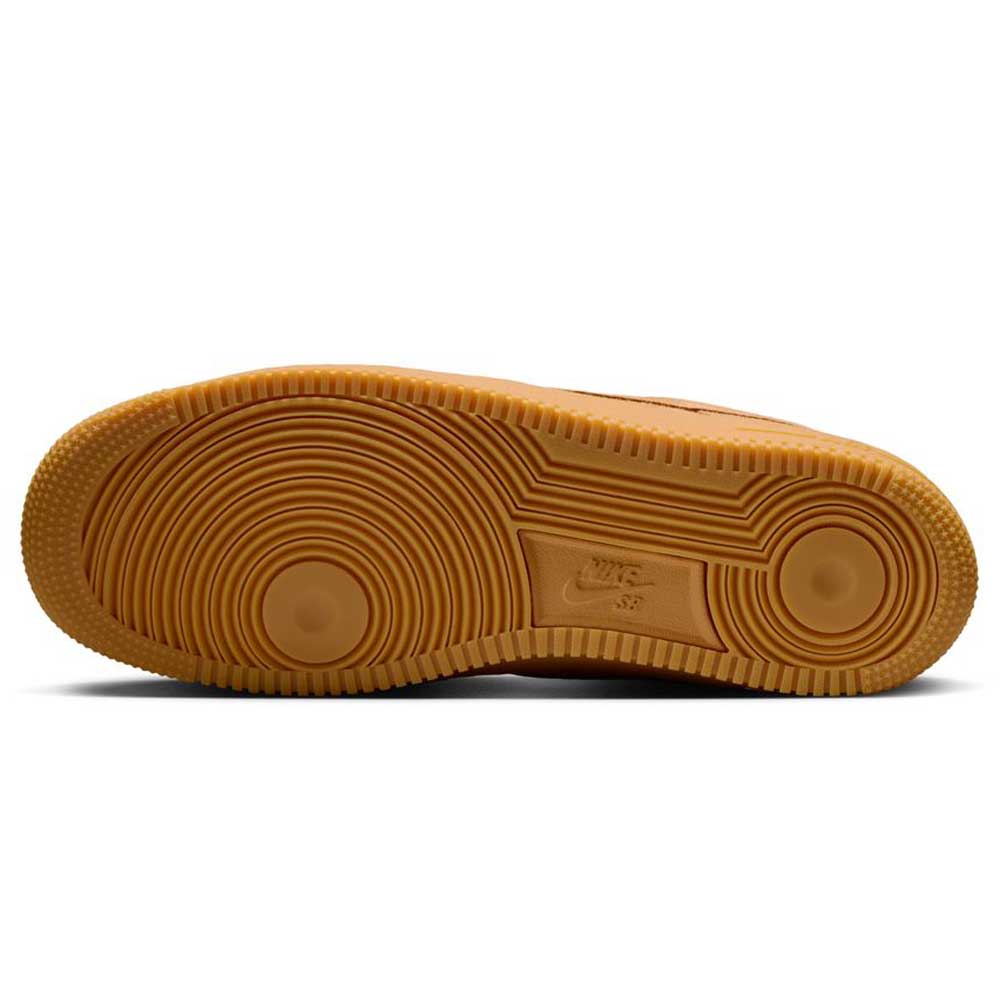 The image displays the gum-colored outsole of the Air Force 1 Flax Black Gum Light Brown HM8517200 Nike SB Suede Skateboarding Shoe, with concentric circles, textured tread for grip, and a central Nike SB logo.